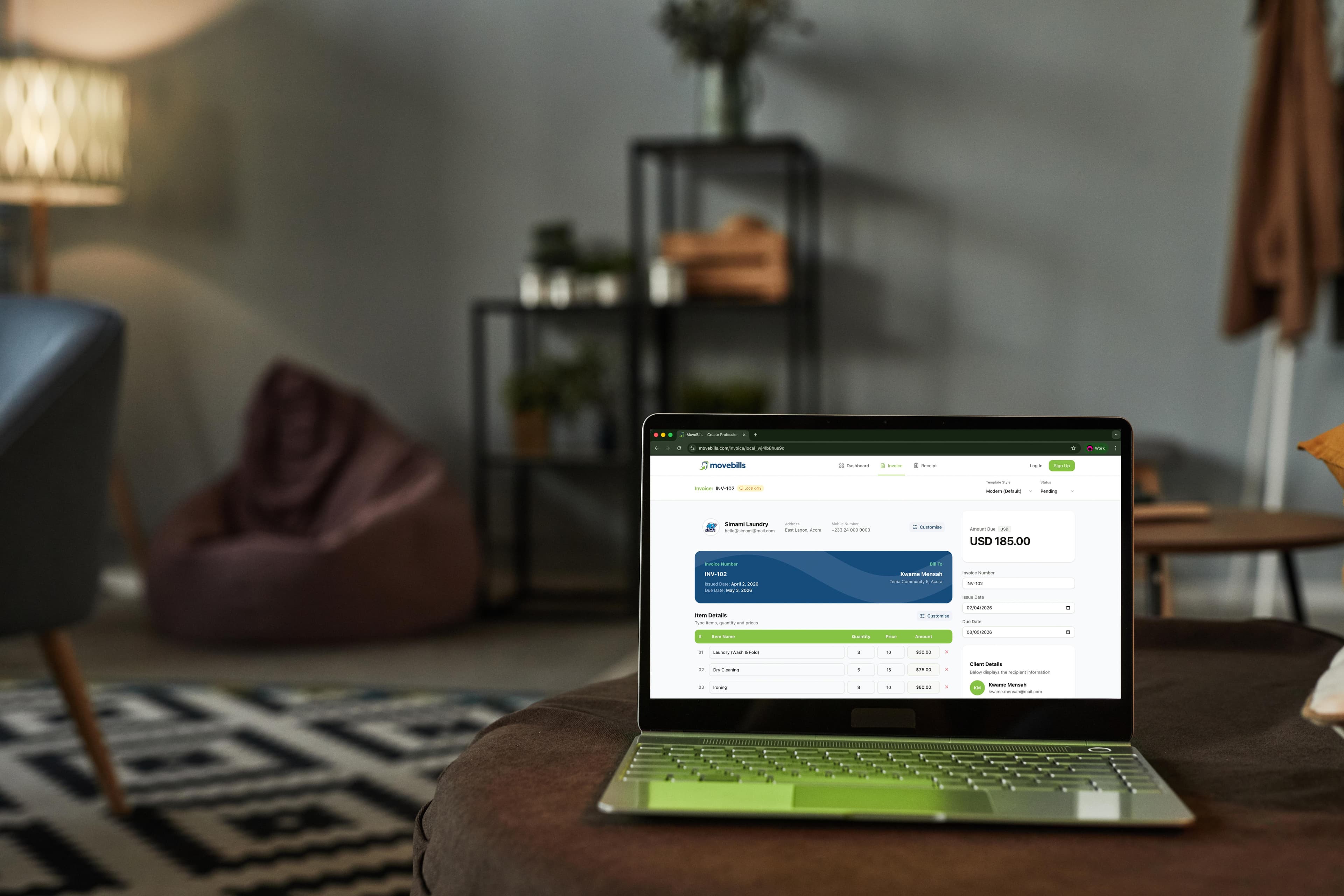 A workspace with a laptop showing a MoveBills invoice